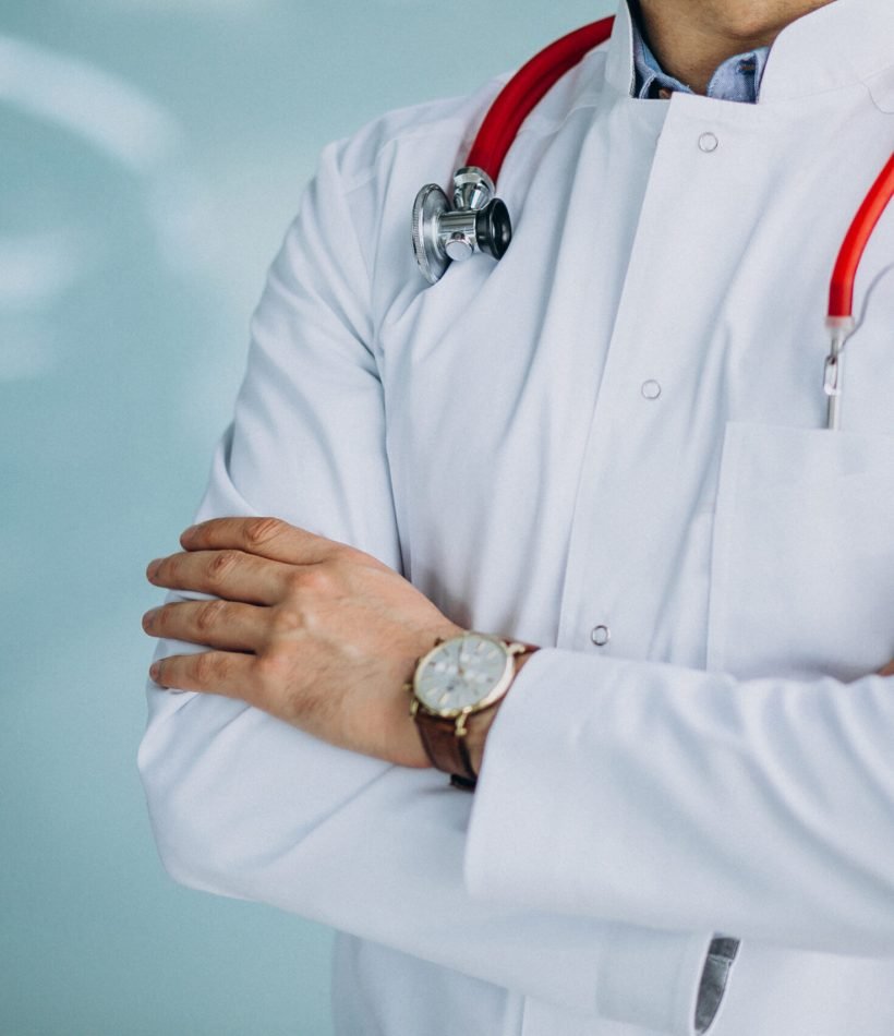 Young handsome physician in a medical robe with stethoscope
